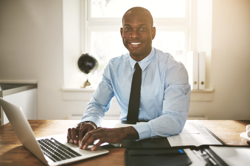 successful,young,african,businessman,sitting,at,his,desk,in,an